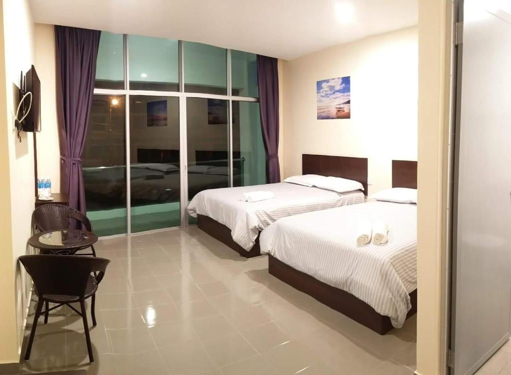 Postel nebo postele na pokoji v ubytování Hotel Pangkor SJ
