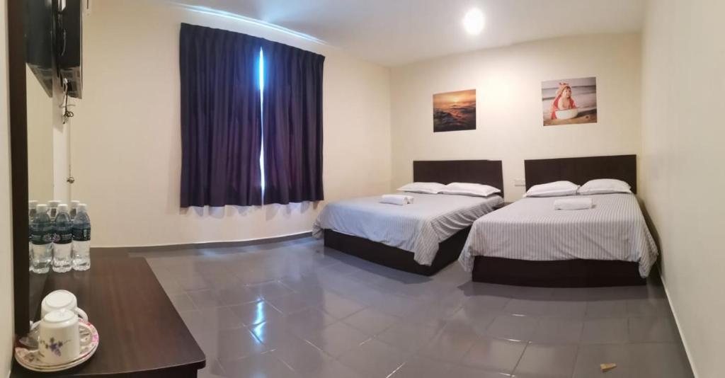 Postel nebo postele na pokoji v ubytování Hotel Pangkor SJ