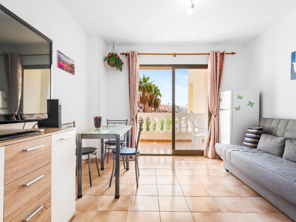 a living room with a couch and a table at 651 Bright establishment, heated pool and Wi Fi in Los Cristianos