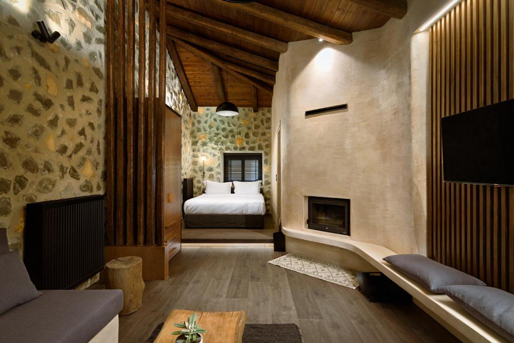a bedroom with a bed and a fireplace at Bocca al Lupo Villas in Kato Loutraki