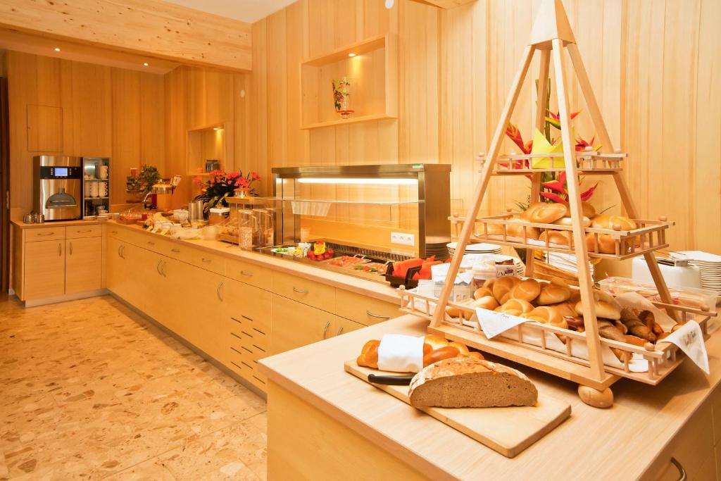 a kitchen with a counter with a shelf of bread at Gasthof Thomann in Velden am Wörthersee