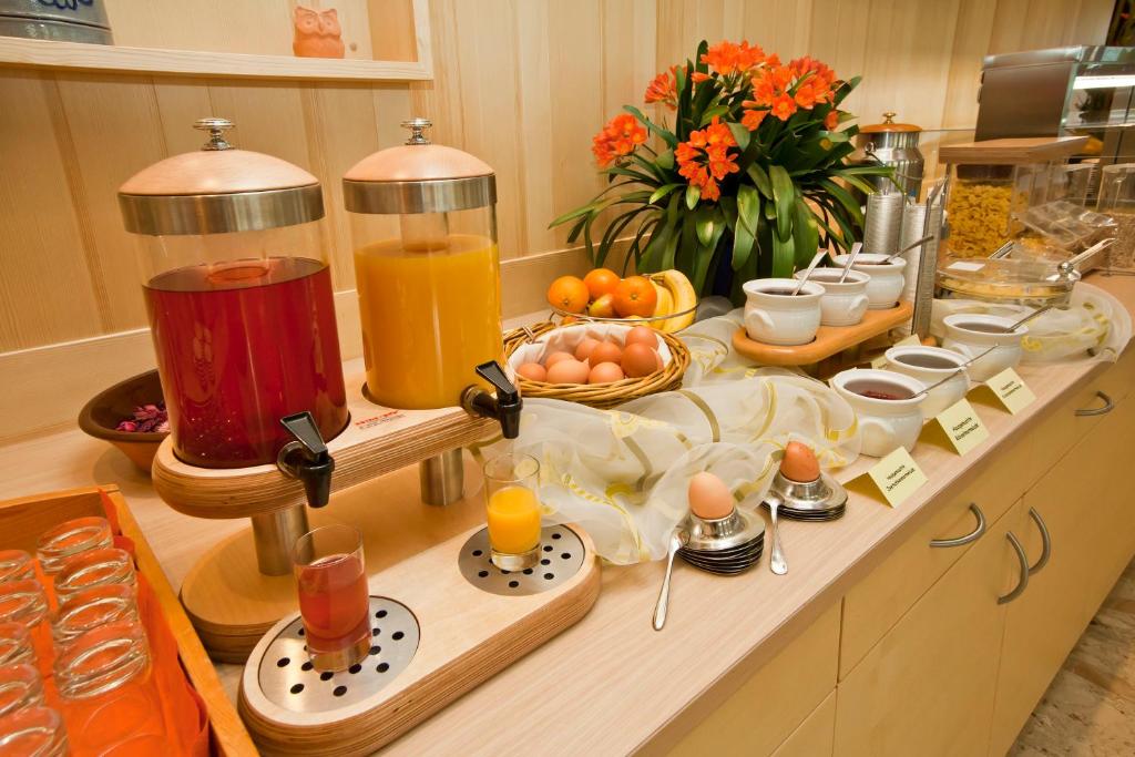 a buffet of breakfast foods and drinks on a kitchen counter at Gasthof Thomann in Velden am Wörthersee