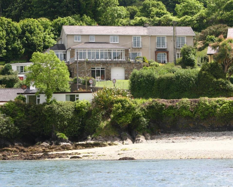 a large house on the shore of a beach at Shearwater Country House Accommodation in Union Hall