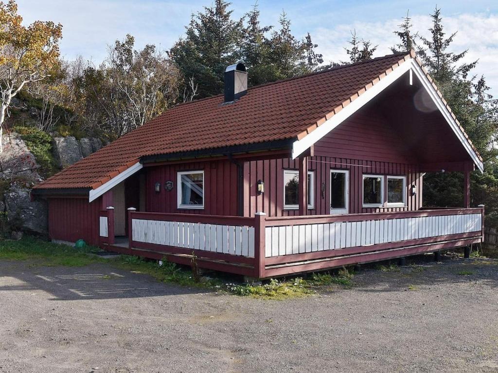 a small red house with a brown roof at 6 person holiday home in Bud in Bud