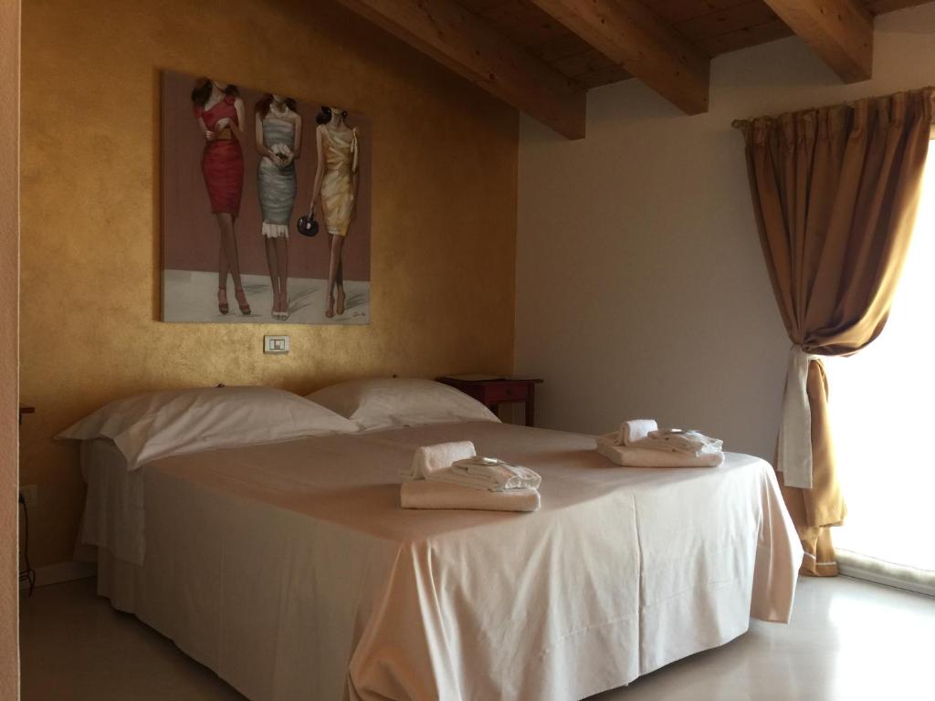 a bedroom with a bed with towels on it at Il Girasole High Quality Inn in Milan