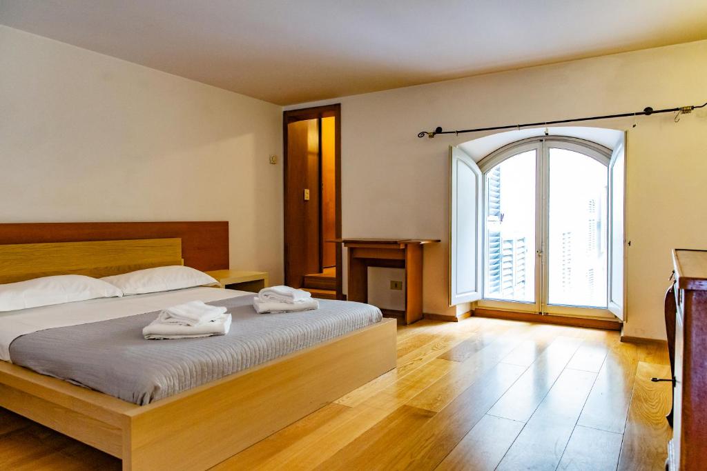 ein Schlafzimmer mit einem Bett mit zwei Handtüchern darauf in der Unterkunft Nice one bedroom in historical building in Florenz