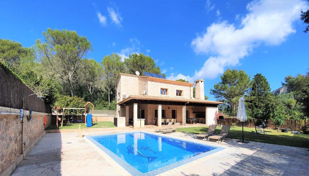 a house with a swimming pool in front of it at Villa Lara in Sa Pobla