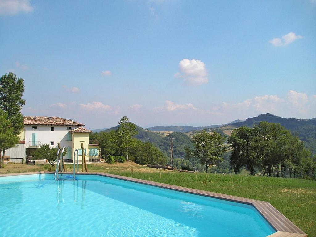 a swimming pool in front of a house at Holiday Home Busani by Interhome in Castello di Contignaco