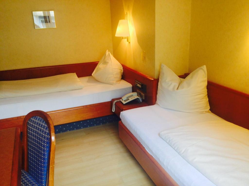 Postel nebo postele na pokoji v ubytování Hotel Carmen
