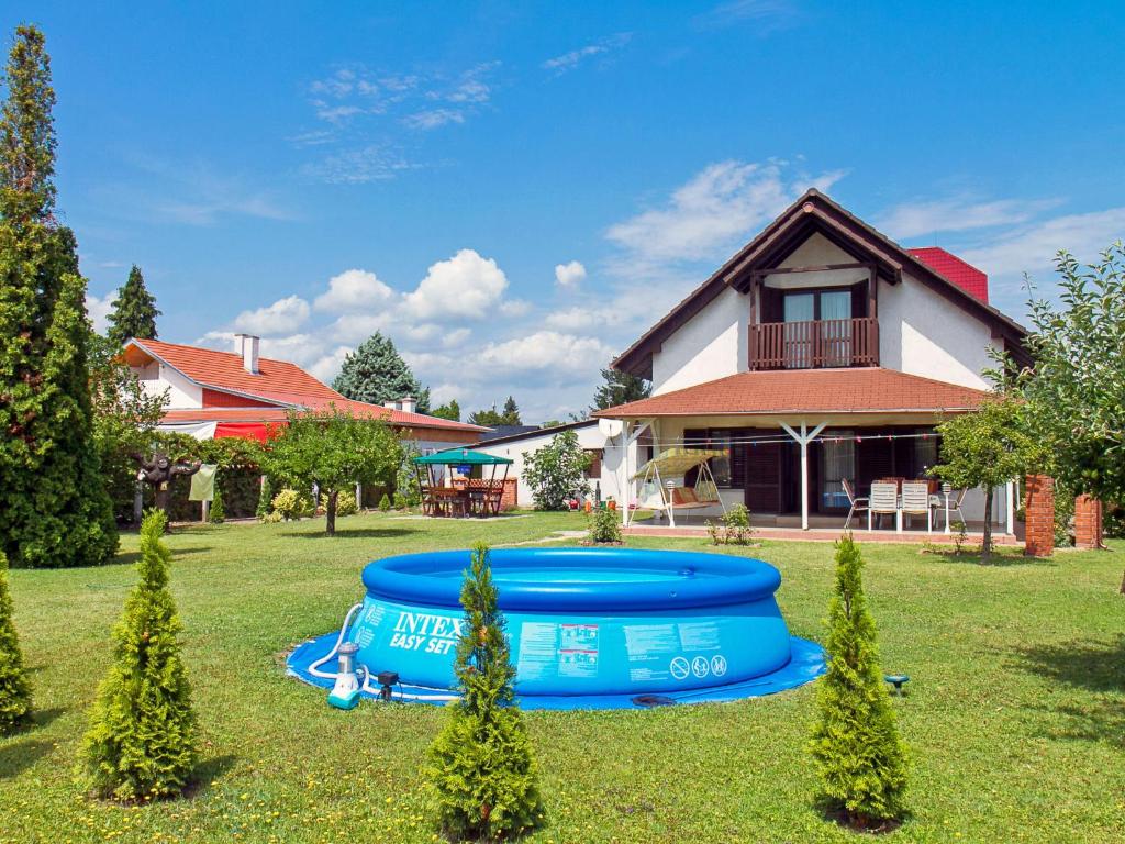 a house with a blue tub in the yard at Holiday Home Grand Jardin by Interhome in Balatonkeresztúr