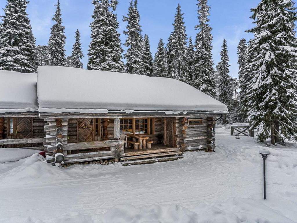 a log cabin with snow on the roof at Holiday Home Seitsemän savua 6 by Interhome in Ruka
