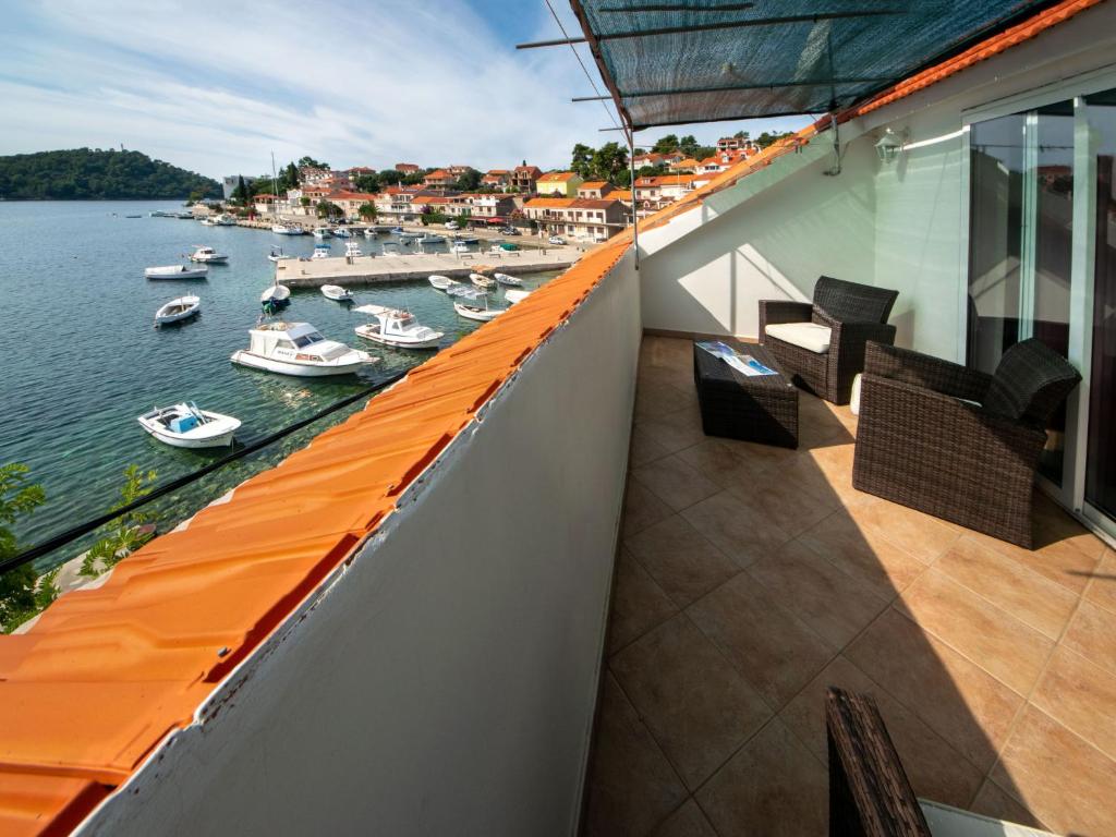 a balcony with a view of the water and boats at Holiday Home Repak by Interhome in Brna