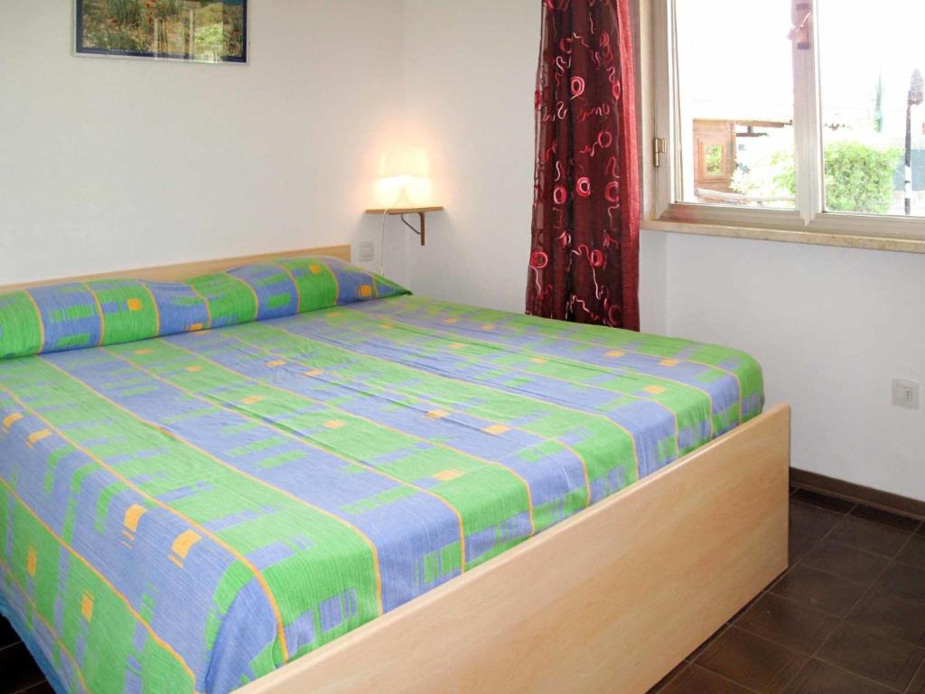 sypialnia z łóżkiem i oknem w obiekcie Apartment Riviera 1 by Interhome w mieście Marina di Cecina