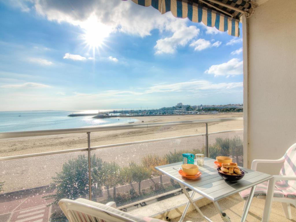 a table and chairs with a view of the beach at Apartment Les Autans by Interhome in Royan