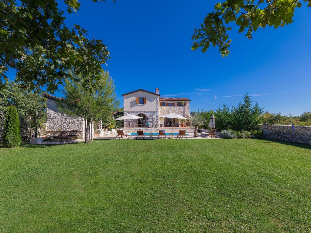 a house with a lawn in front of it at Villa Histria 1 by Interhome in Čabrunići