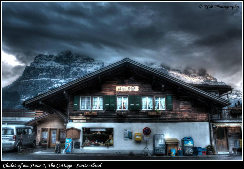 a building with a snow covered mountain in the background at Chalet uf em Stutz 1 in Grindelwald
