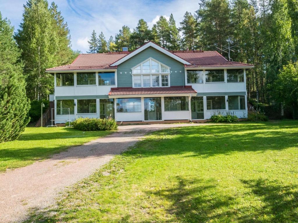 a large house with a large yard at Holiday Home Vadelma by Interhome in Kukkola