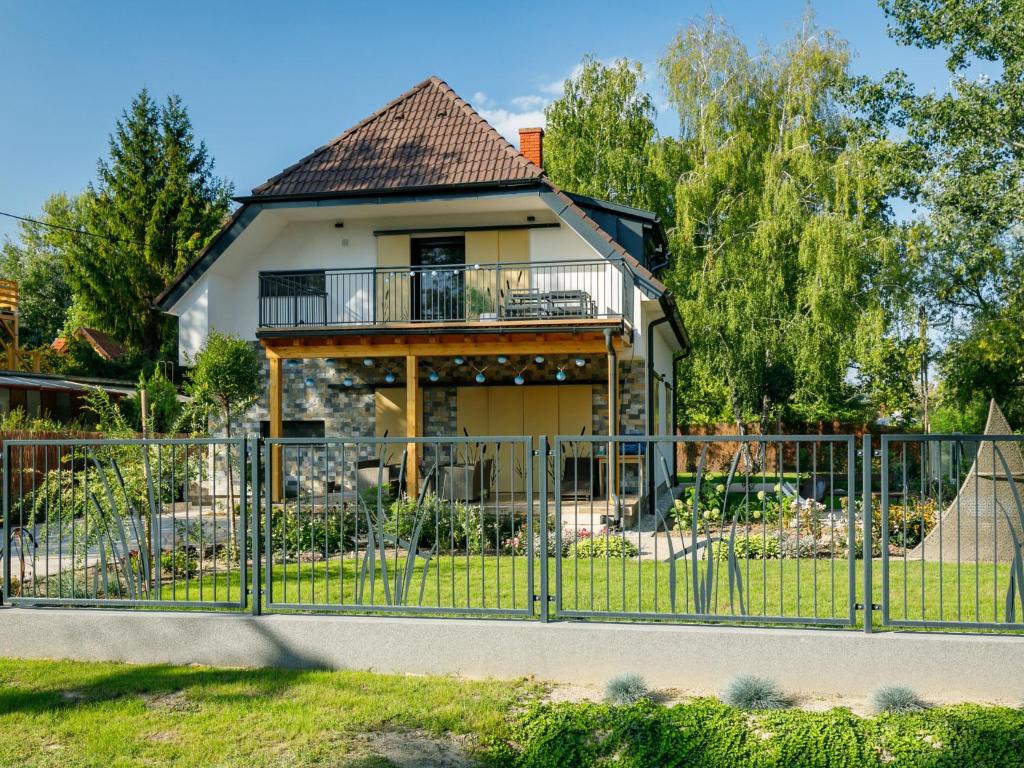 a house with a fence in front of it at Apartment Erika by Interhome in Balatonszárszó