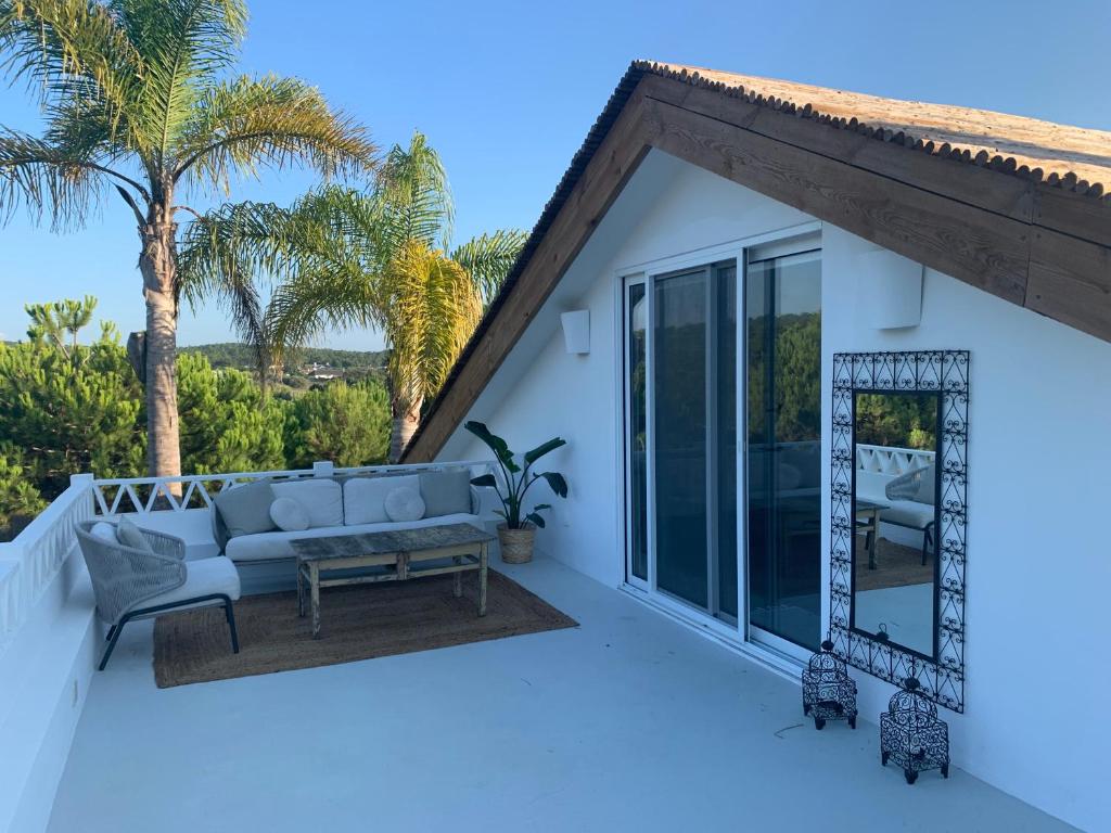 a patio with a couch and a table at Lovely 2-bedroom apartment- Comporta in Carvalhal