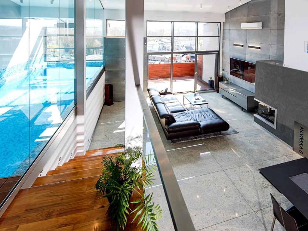 two images of a living room with a swimming pool at Młyńska 8 Apartament z prywatnym basenem in Bielsko-Biała