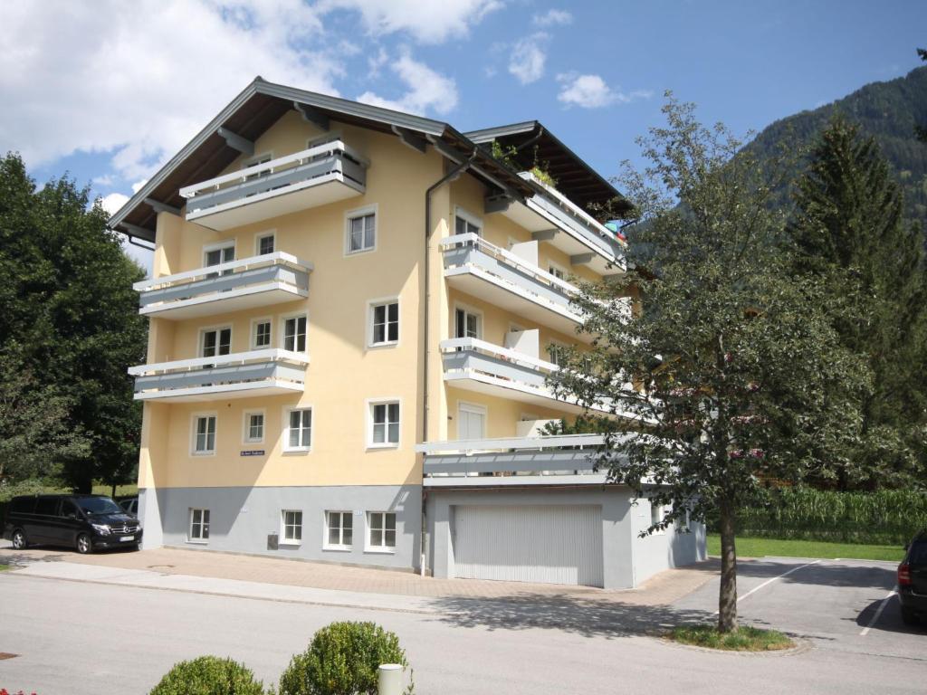 a yellow building with a tree in front of it at Apartment Stefanie-2 by Interhome in Bad Hofgastein