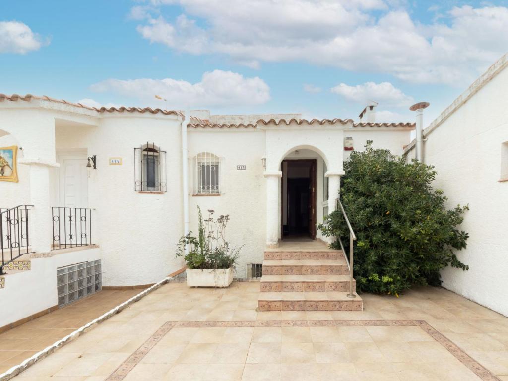 a white house with a courtyard and stairs at Holiday Home Stefi by Interhome in Peniscola