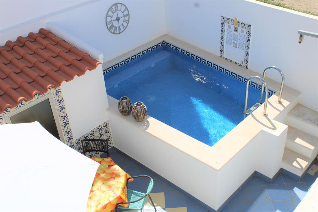 a swimming pool in a house with a tile roof at Casa Colorida in Porches