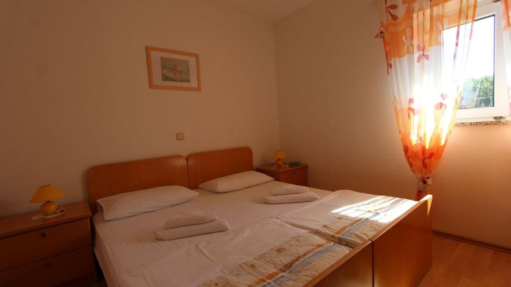 Postel nebo postele na pokoji v ubytování Apartments Damir