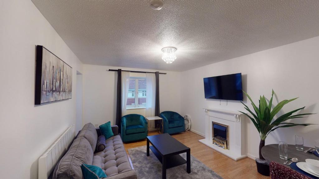 a living room with a couch and a fireplace at JEGS Estate in Thamesmead