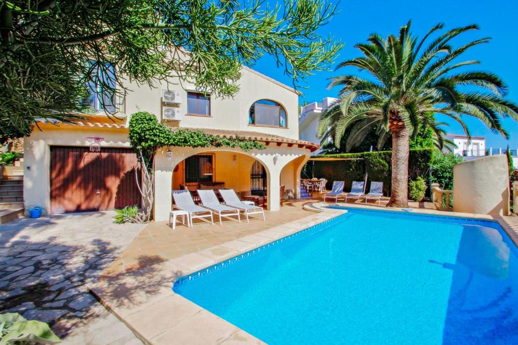 a villa with a swimming pool and a house at Sola - pretty holiday property with garden and private pool in Benissa in Benissa