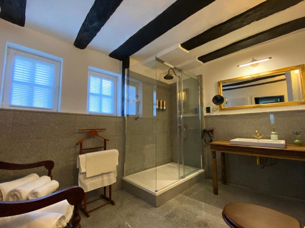 a bathroom with a glass shower and a sink at Villa Dornröschen Grebenstein in Grebenstein