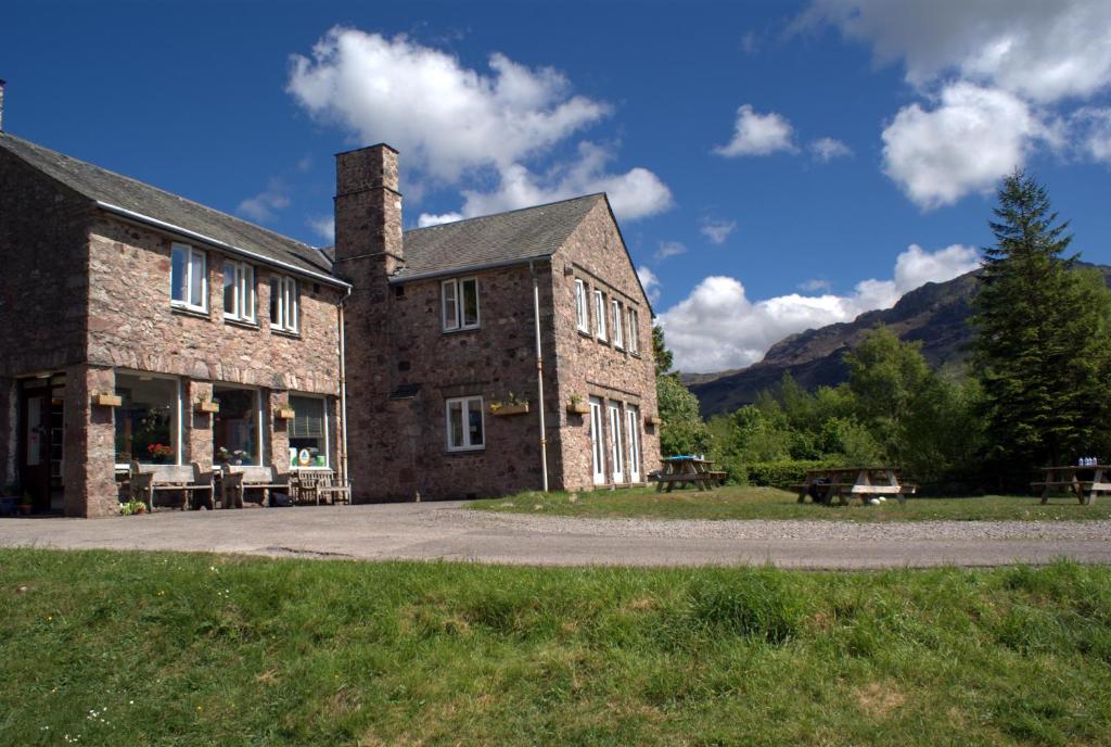 a large brick building with a picnic table in front of it at YHA Eskdale in Eskdale