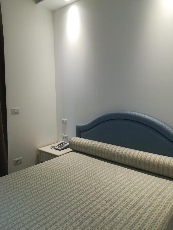 Postel nebo postele na pokoji v ubytování Hotel Flora