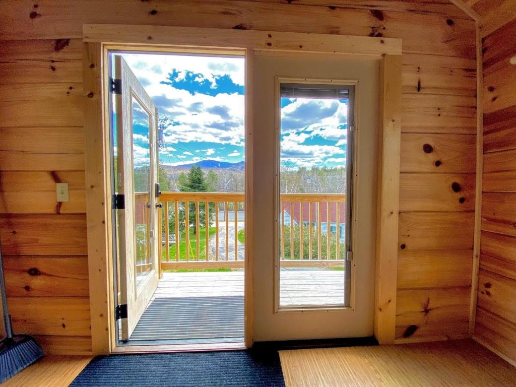 a room with a door leading to a balcony at B11 NEW Awesome Tiny Home with AC Mountain Views Minutes to Skiing Hiking Attractions in Carroll