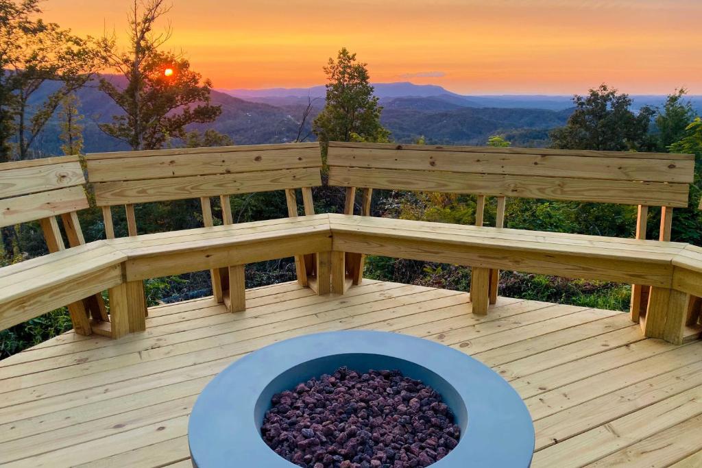a bowl of purple rocks on a deck with a sunset at Upscale Gatlinburg Cabin Deck, Fire Pit and Hot Tub in Gatlinburg