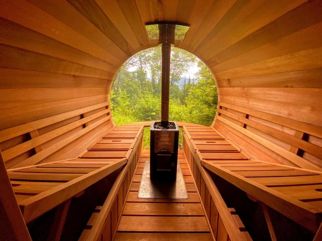 a inside of a wooden sauna with a window at NEW Stunning home with breathtaking views, outdoor cedar sauna, great location in Franconia