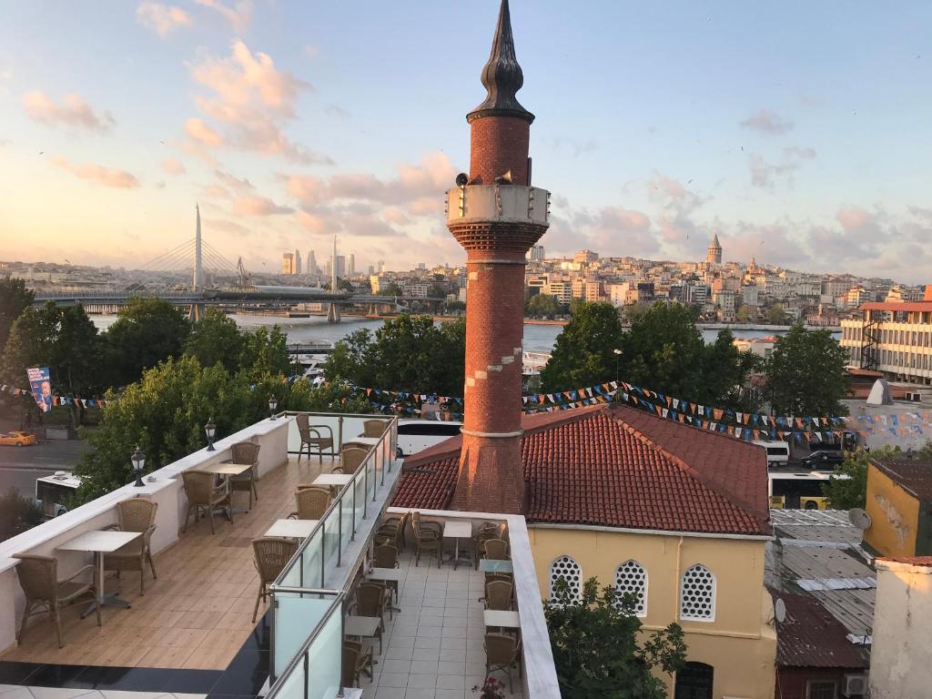 a building with a clock tower on top of a roof at Altınboynuz Family Hotel in Istanbul