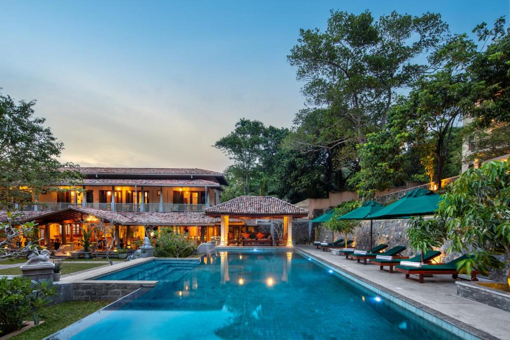 an exterior view of a resort with a swimming pool at Green Escape Unawatuna in Unawatuna