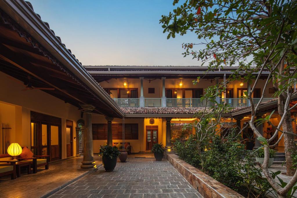 a courtyard of a house with a walkway at Green Escape Unawatuna in Unawatuna