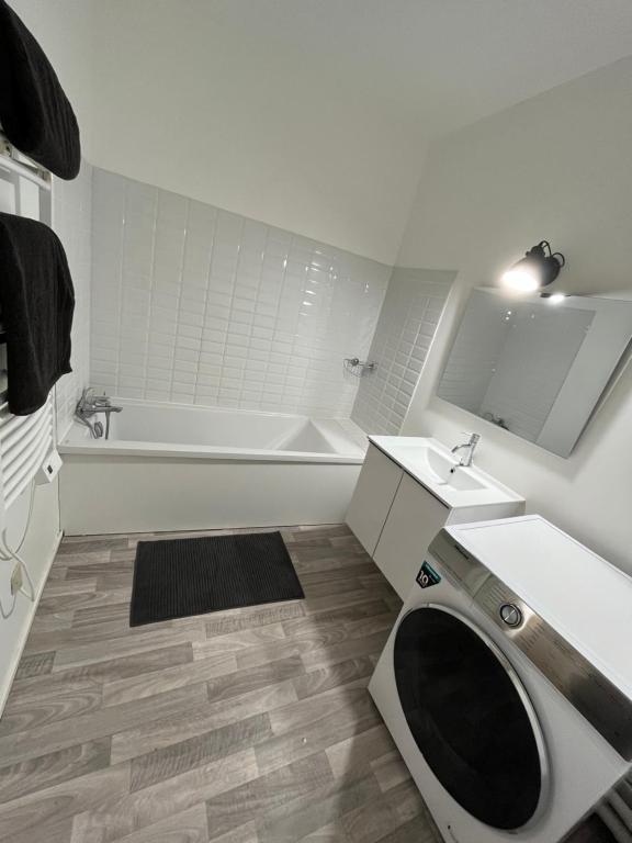 a bathroom with a toilet and a sink and a tub at New&Cosy - Near Disney/Paris - 100m RER A in Lognes