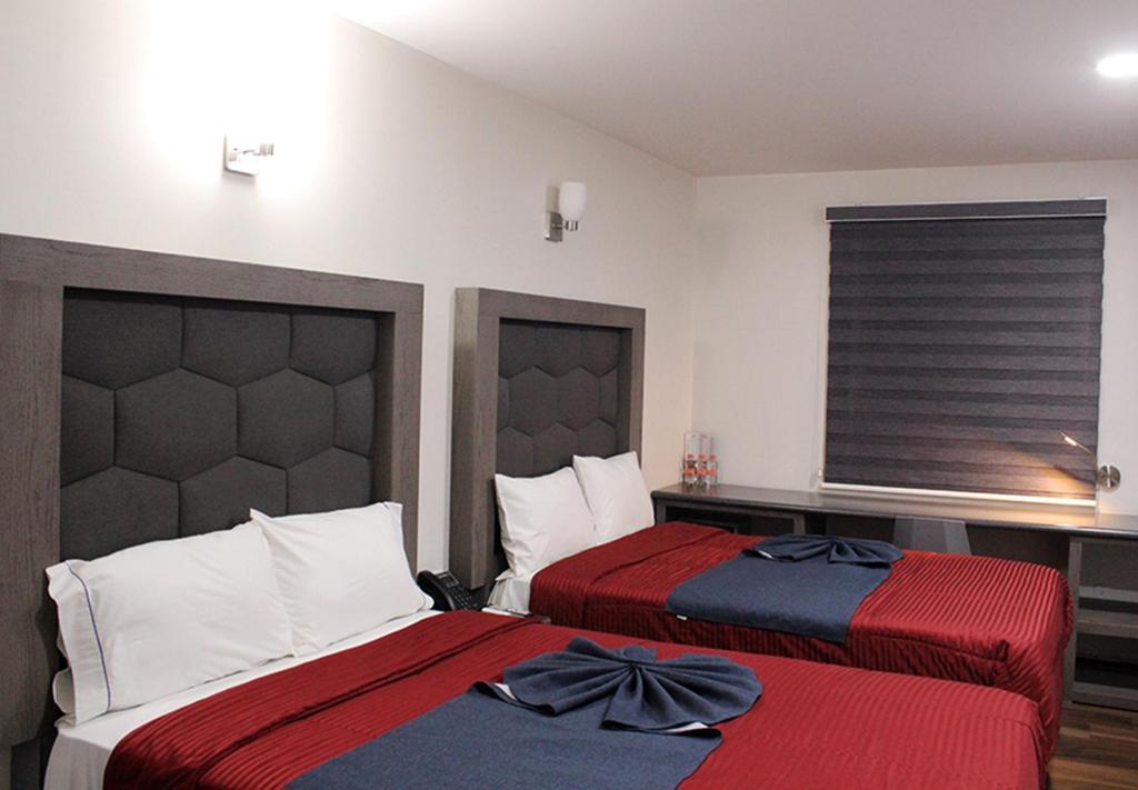Postel nebo postele na pokoji v ubytování Hotel ANB Aeropuerto Guadalajara