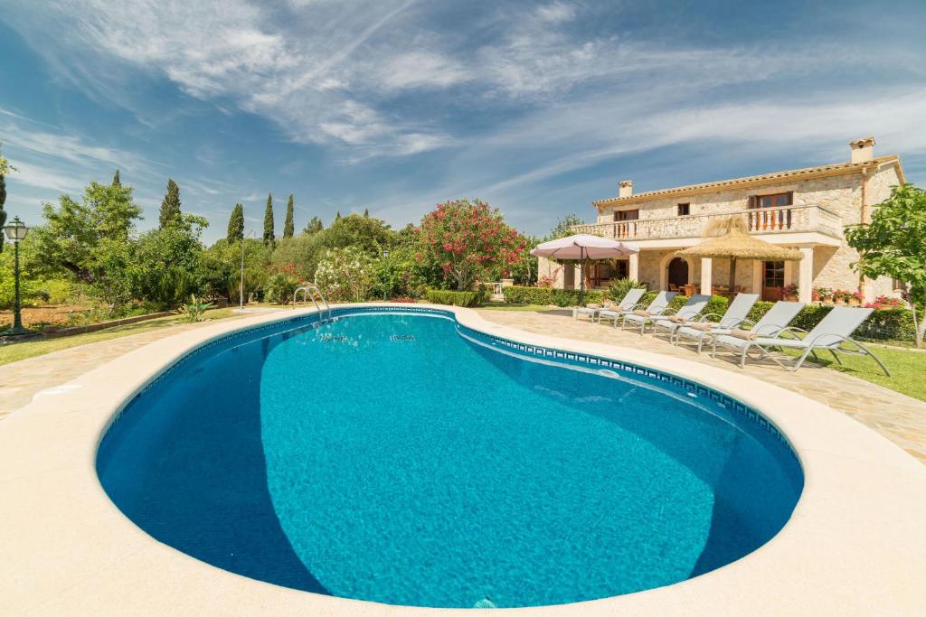 a swimming pool in front of a villa at Estern in Pollença