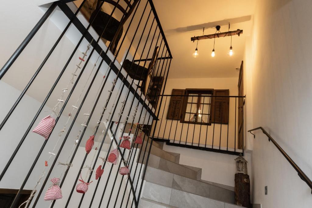 a hallway with stairs with baskets on the railing at Agritur E-Cinque in Salorno