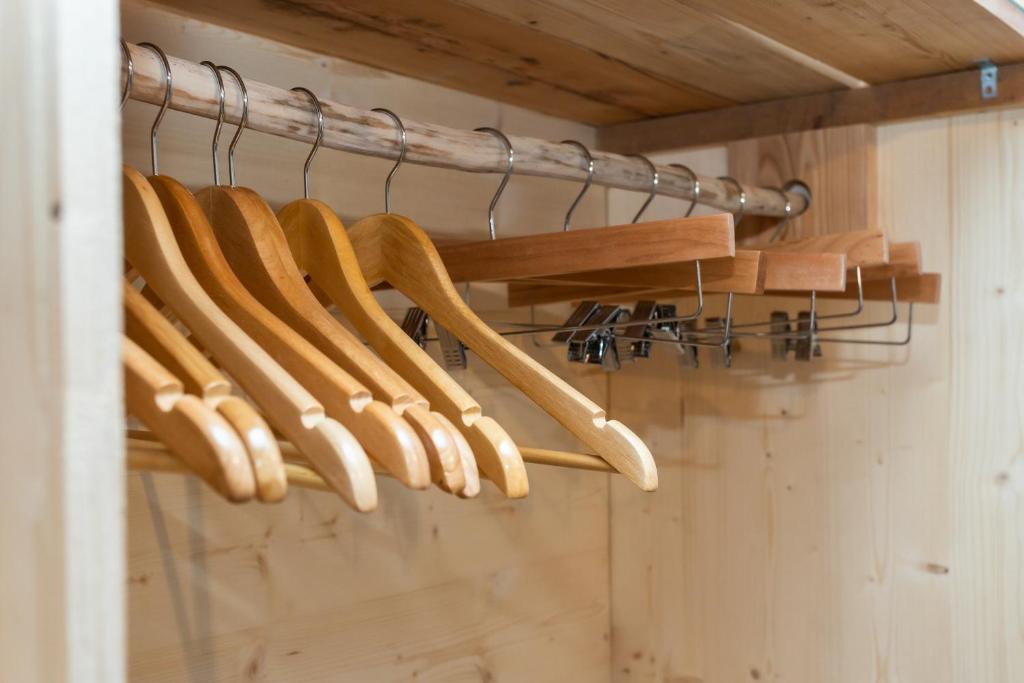 a bunch of wooden bats hanging on a rack at Agritur E-Cinque in Salorno