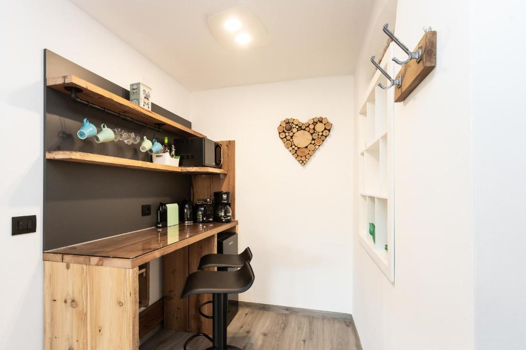 a kitchen with a wooden counter and a chair at Agritur E-Cinque in Salorno