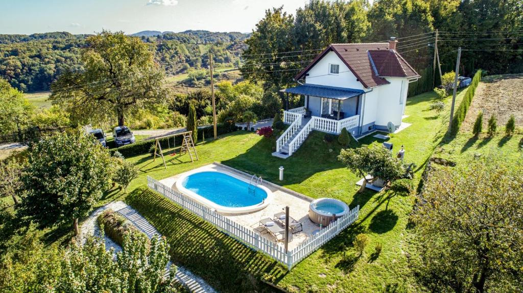 an aerial view of a house with a swimming pool at Odisea Hill House - Modern Holiday Home with swimming pool, sauna, jacuzzi, WiFi and 2 bedrooms, near Varazdin in Gačice