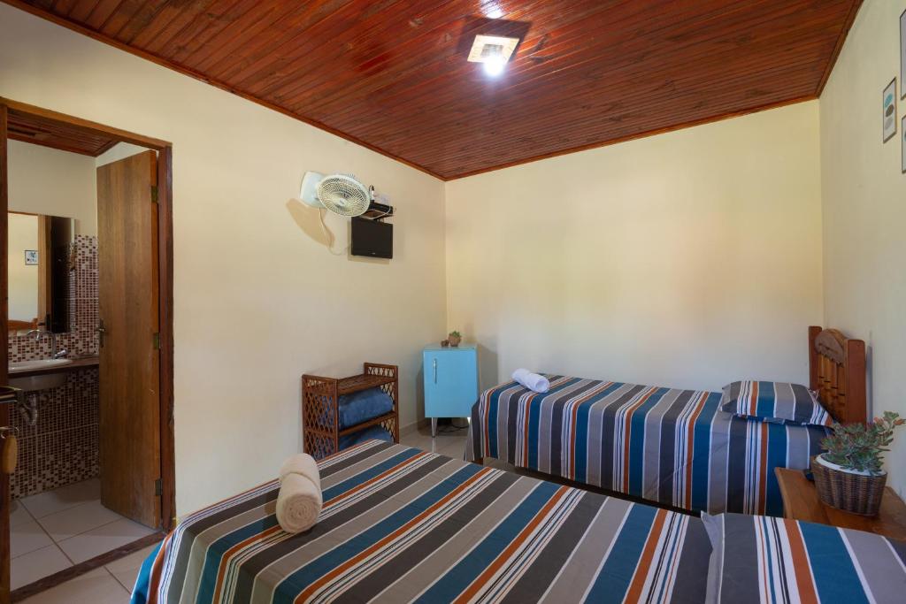 Cama ou camas em um quarto em Pousada Aconchego