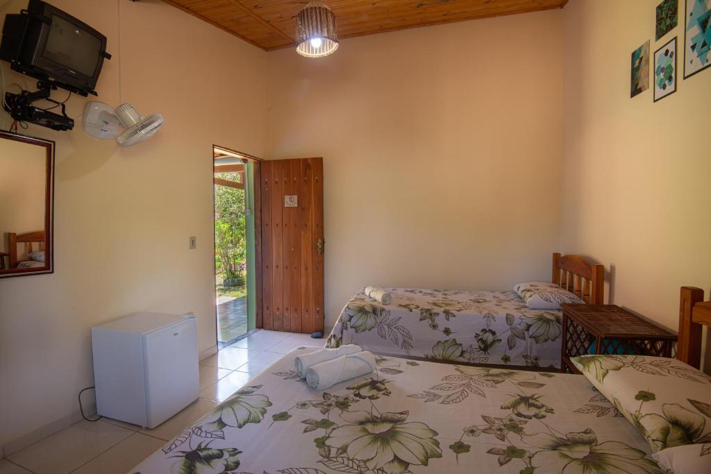 Cama ou camas em um quarto em Pousada Aconchego