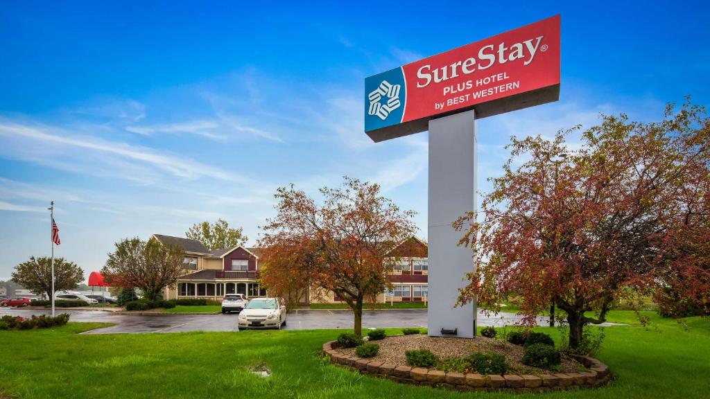 a sign for a hotel in a parking lot at SureStay Plus Hotel by Best Western Auburn in Auburn