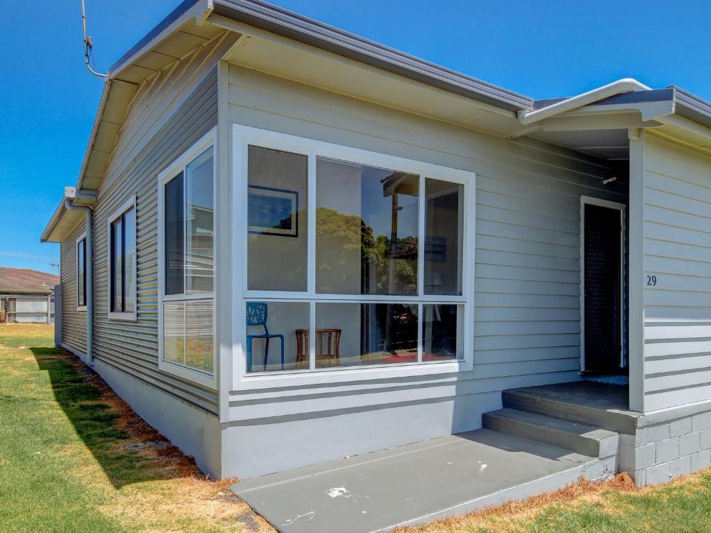 a house with sliding glass doors on it at Wings and Waves in Port Fairy
